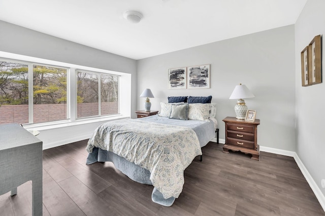 bedroom with dark hardwood / wood-style flooring