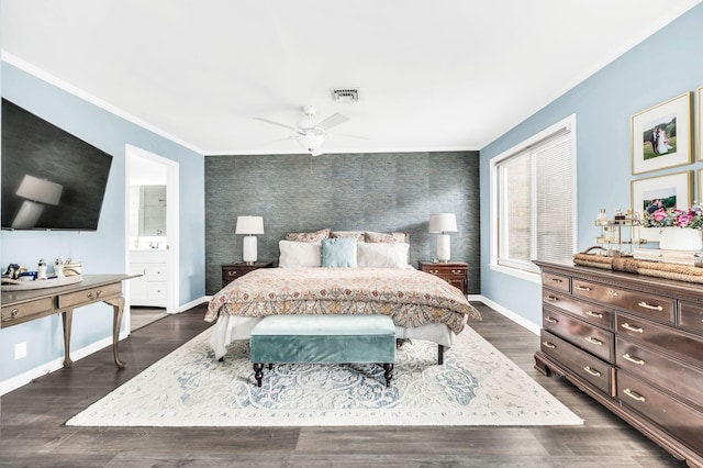 bedroom with crown molding, ensuite bath, dark hardwood / wood-style floors, and ceiling fan