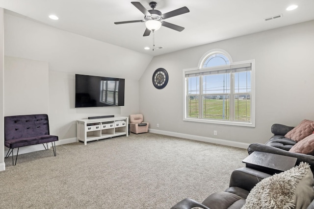 living room featuring carpet floors, ceiling fan, and vaulted ceiling