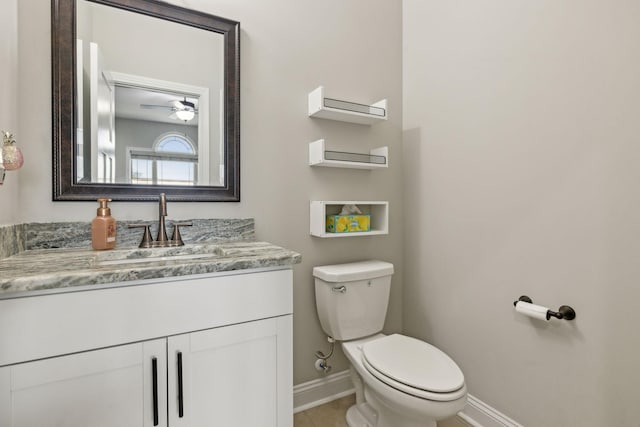 bathroom with vanity, ceiling fan, tile patterned flooring, and toilet