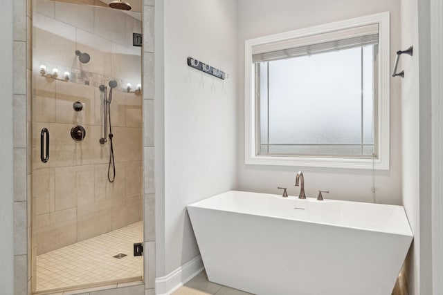 bathroom with a healthy amount of sunlight, separate shower and tub, and sink