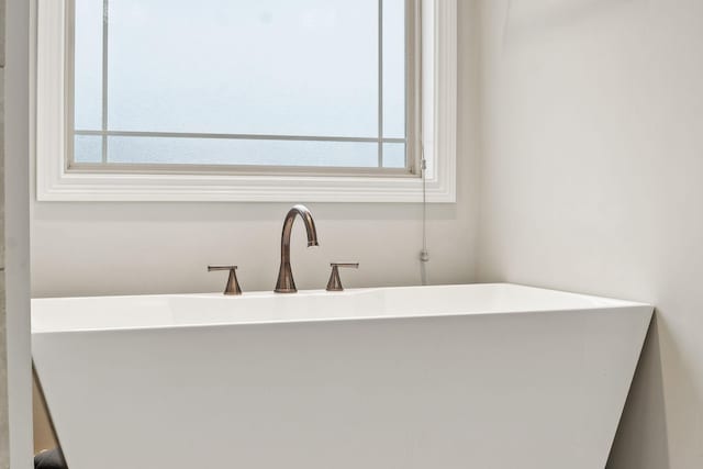 bathroom with plenty of natural light and a bathtub