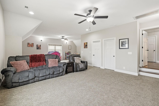 carpeted living room featuring ceiling fan and vaulted ceiling