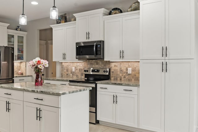 kitchen featuring stainless steel appliances, pendant lighting, white cabinets, and light stone counters