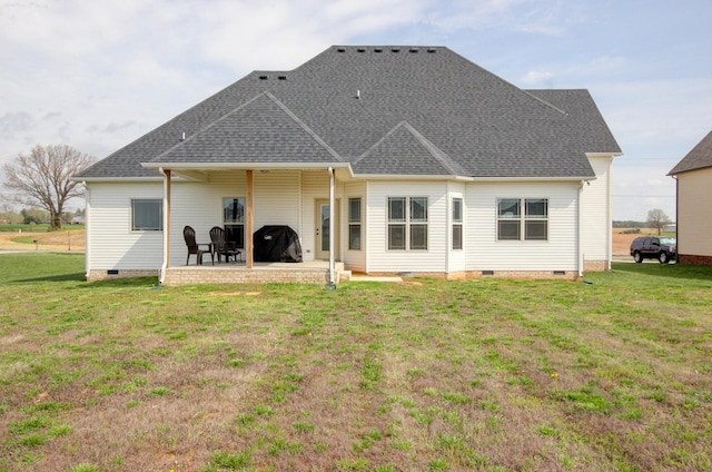 rear view of house featuring a yard and a patio area