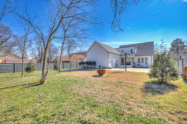 back of property featuring a yard and a patio