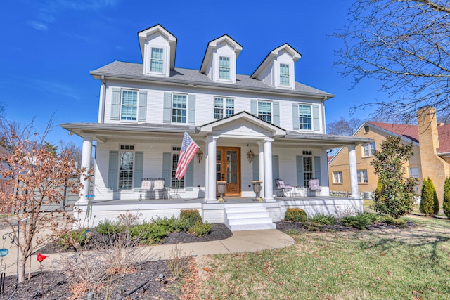 colonial house featuring a front yard and a porch