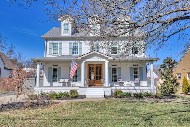 colonial home with a front yard and covered porch