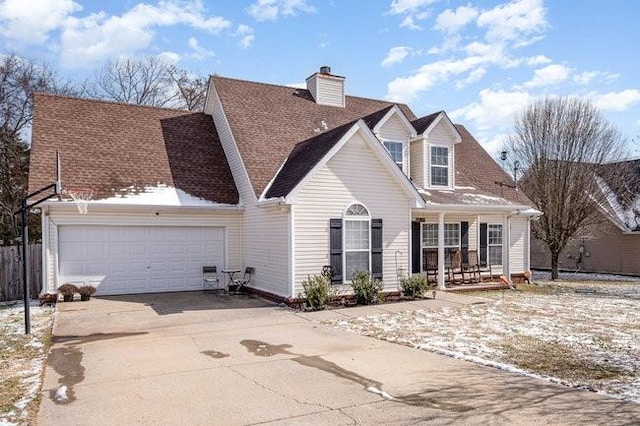 cape cod-style house with a garage, concrete driveway, a chimney, roof with shingles, and a porch