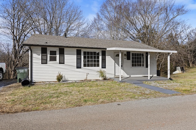 single story home featuring a carport and a front yard