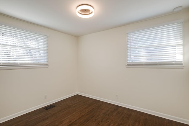 empty room with hardwood / wood-style flooring