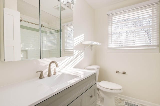 bathroom with walk in shower, vanity, and toilet