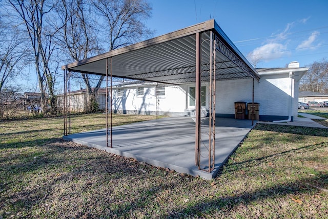 view of vehicle parking featuring a carport and a yard