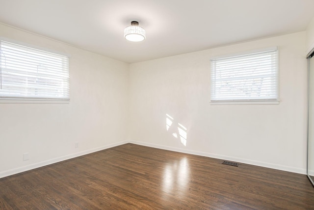 unfurnished room with dark hardwood / wood-style floors