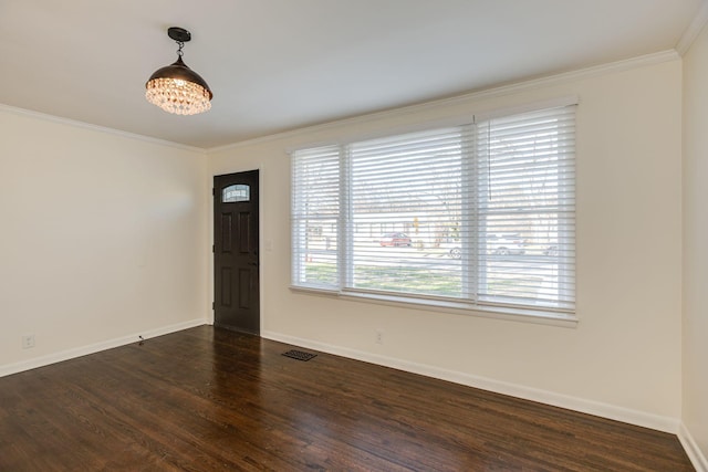 foyer featuring crown molding and dark wood-type flooring