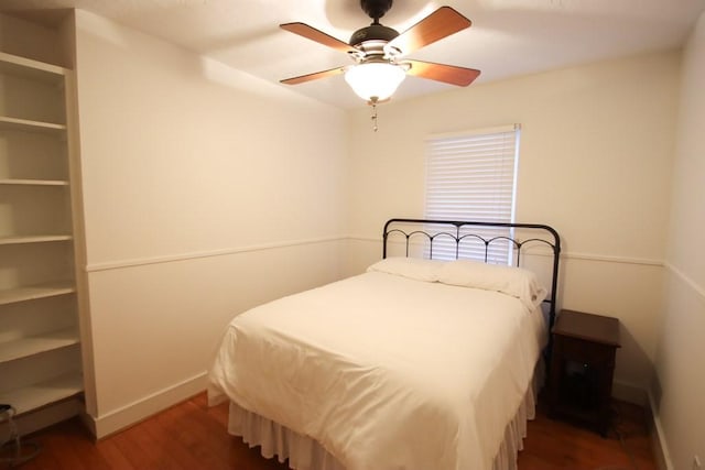 bedroom with dark wood-type flooring and ceiling fan