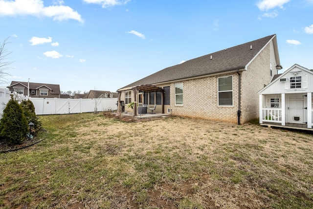 back of property featuring a pergola, a patio area, and a lawn