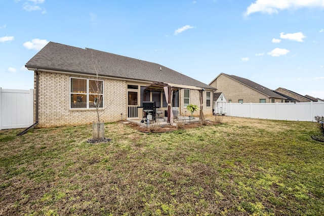 rear view of house featuring a yard, a pergola, and a patio