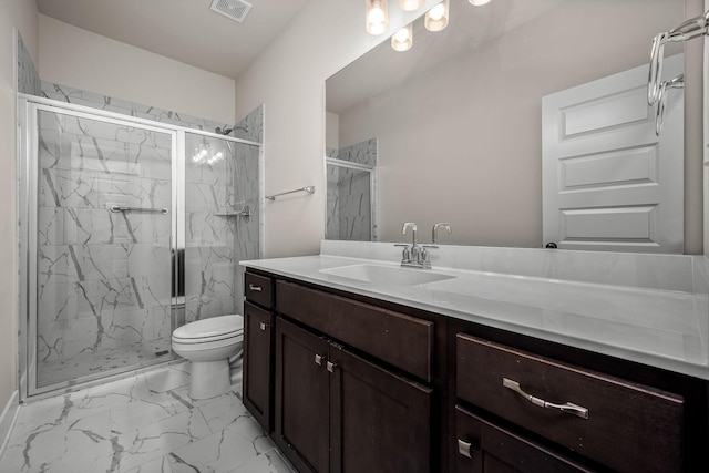 bathroom with vanity, a shower with door, and toilet