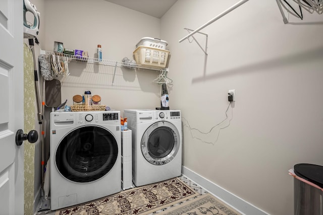 clothes washing area featuring independent washer and dryer