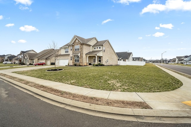 view of front of home featuring a garage and a front lawn