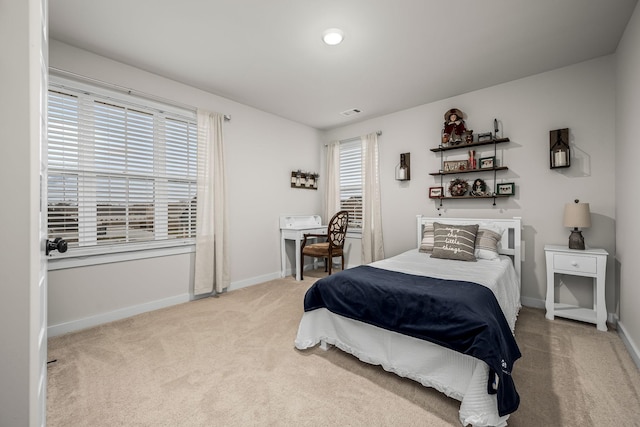 carpeted bedroom featuring multiple windows