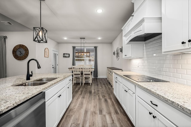 kitchen with sink, dishwasher, premium range hood, white cabinets, and black electric cooktop