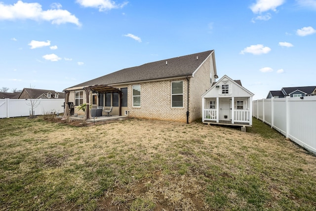 rear view of house with a lawn, a pergola, a patio area, central air condition unit, and an outbuilding