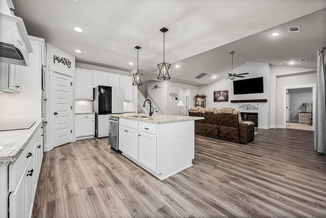 kitchen featuring white cabinetry, stainless steel dishwasher, sink, and a center island with sink