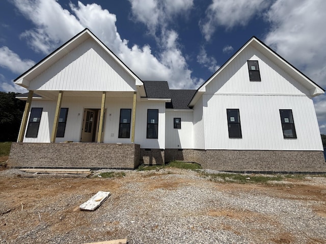 3944 Chapel Hill Rd, Clarksville, TN 37040 - modern inspired farmhouse featuring a porch, a shingled roof, and brick siding