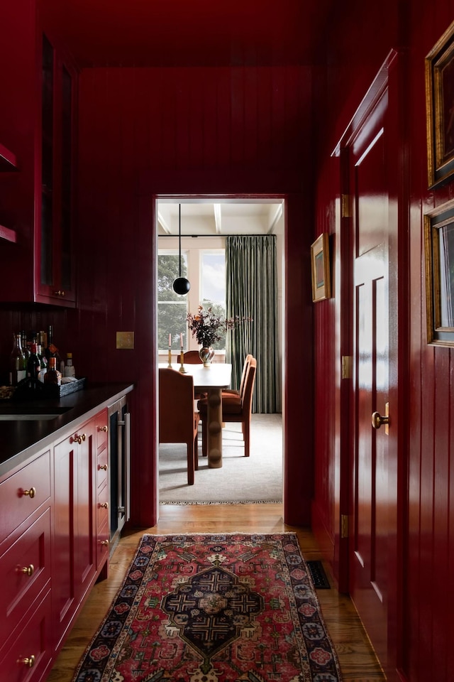 interior space featuring beverage cooler and light hardwood / wood-style flooring