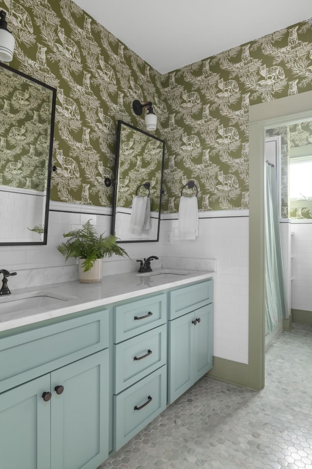 bathroom with vanity and tile walls