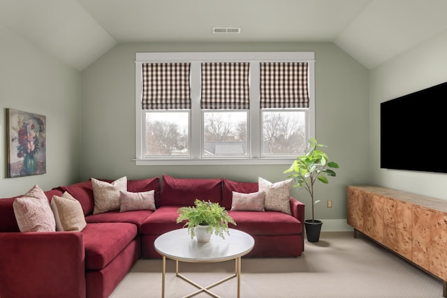 carpeted living room featuring vaulted ceiling