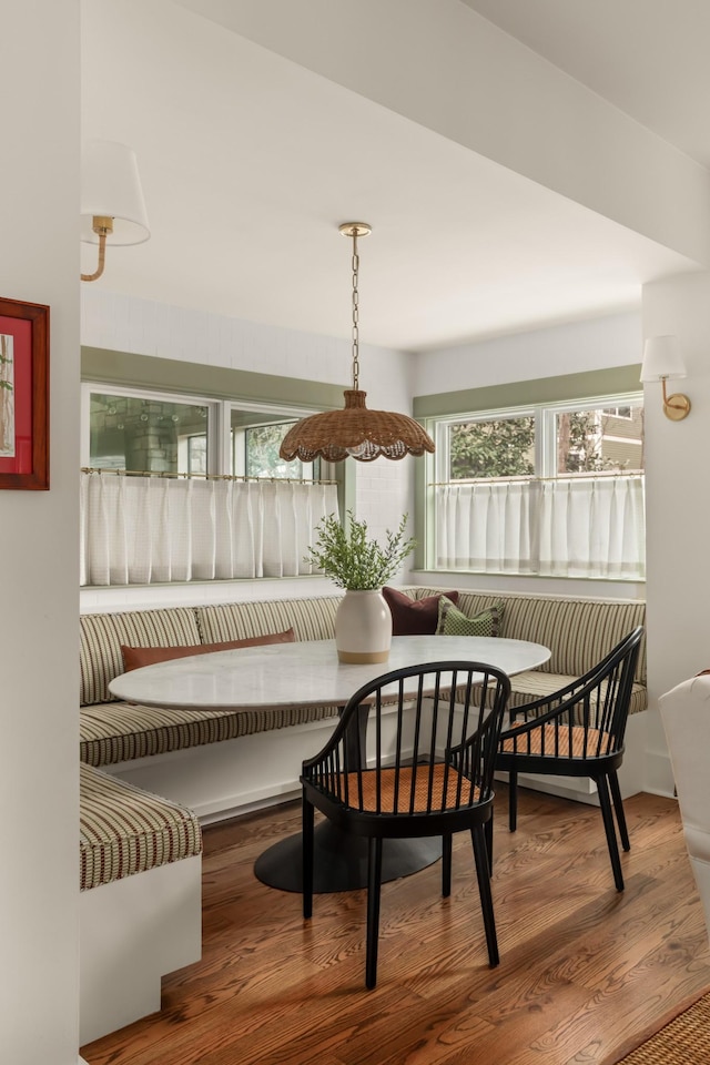 dining area featuring breakfast area and wood-type flooring