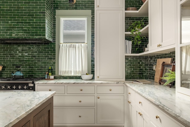 kitchen with light stone countertops and white cabinets