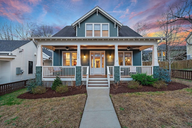 view of front of property with a yard, ceiling fan, and a porch