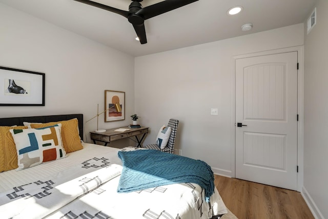 bedroom featuring ceiling fan and light hardwood / wood-style flooring