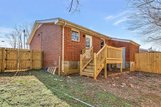 rear view of house featuring cooling unit