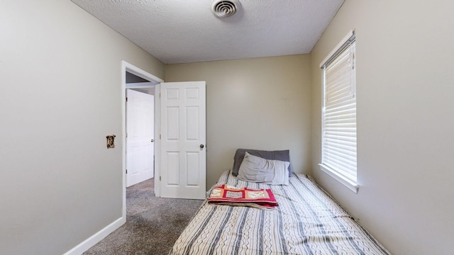 carpeted bedroom featuring a textured ceiling