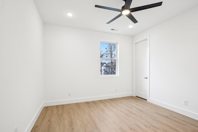 empty room featuring ceiling fan and light hardwood / wood-style floors