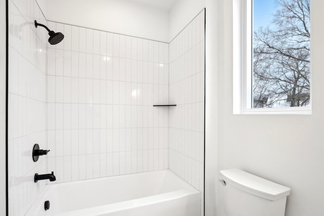 bathroom featuring tiled shower / bath and toilet