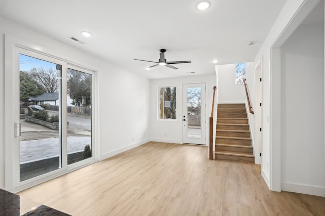 unfurnished living room with ceiling fan and light hardwood / wood-style flooring