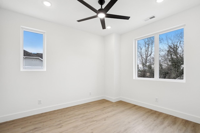 spare room with ceiling fan and light hardwood / wood-style flooring