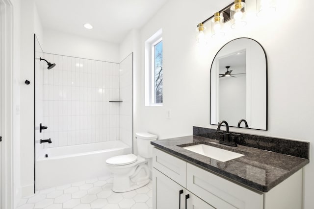 full bathroom featuring ceiling fan, tiled shower / bath combo, vanity, tile patterned floors, and toilet