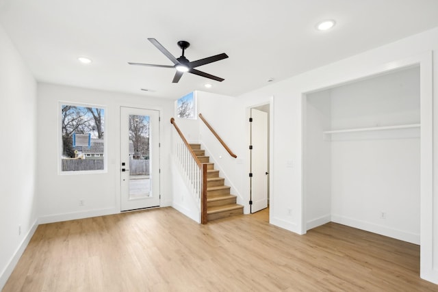 foyer with ceiling fan and light wood-type flooring