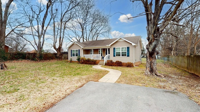 view of front of home with covered porch and a front lawn