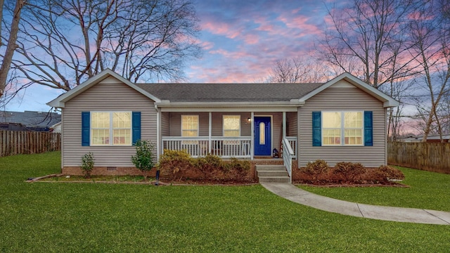 ranch-style house featuring a porch and a yard