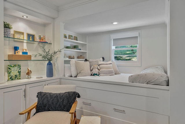 living area with crown molding