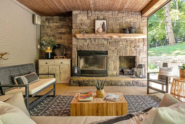 living room with light tile patterned floors, wood ceiling, and a fireplace