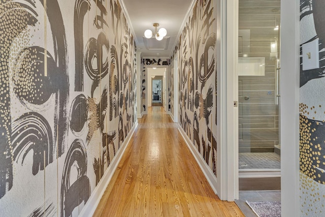 hallway with a chandelier and light wood-type flooring